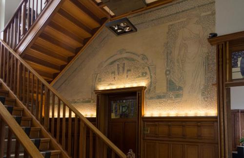 a staircase in a building with a painting on the wall at Boutique hotel Shamon in Eeklo