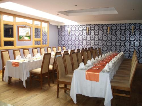 a row of tables in a room with chairs and tablesearcher at Broadhaven Bay Hotel in Belmullet