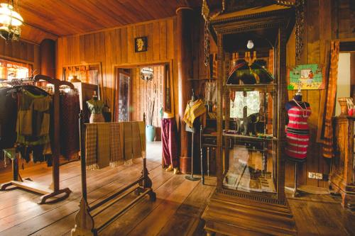 a clothing store with clothes on display in a room at Terres Rouges Lodge in Banlung