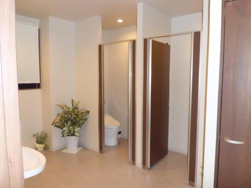 a bathroom with two open doors and a toilet at BEPPU ROJIURA stay&sauna in Beppu