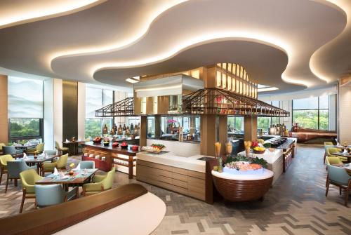 a rendering of a restaurant with tables and chairs at Shangri-La Jinan in Jinan
