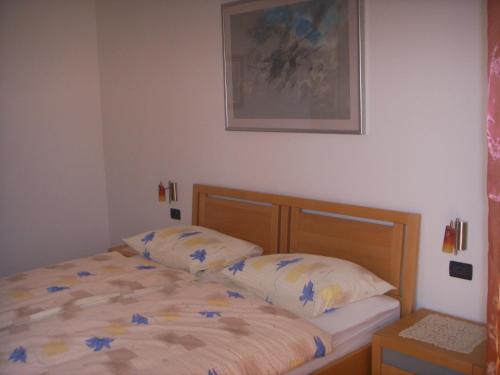 a bedroom with a bed and a picture on the wall at Apartments Ana Wellness L in Rovinj