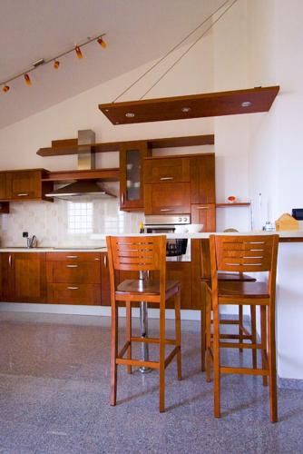a kitchen with two chairs and a table and a stove at Apartments Ana Wellness L in Rovinj