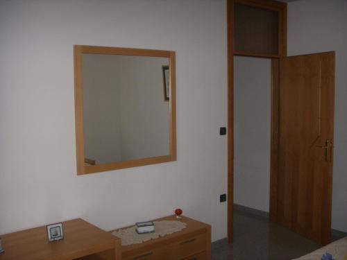 a room with a mirror on the wall and a table at Apartments Ana Wellness L in Rovinj