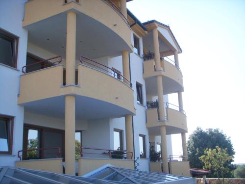 a building with balconies on the side of it at Apartments Ana Wellness L in Rovinj