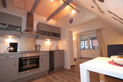 a kitchen with stainless steel appliances and wooden floors at Altstadtferienwohnung Stade-Cozy Home -ein zweites Zuhause finden in Stade