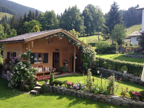 a cottage in the mountains with a garden at Ferienwohnung Mitteldorf in Oberammergau