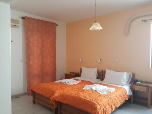 a bedroom with a bed with towels on it at Amaryllis Hotel in Karpathos