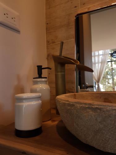 a bathroom counter with a sink and a mirror at La Quinta Glamping - Lago de Tota in Cuítiva