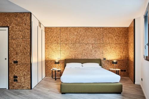 a bedroom with a white bed and two tables at La Perla by Sedar in Como