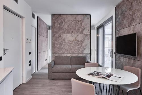 a living room with a table and a couch at La Perla by Sedar in Como