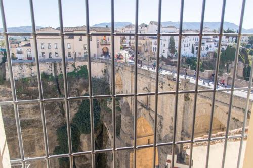 a view of the city from behind a fence at Hotel Don Miguel in Ronda