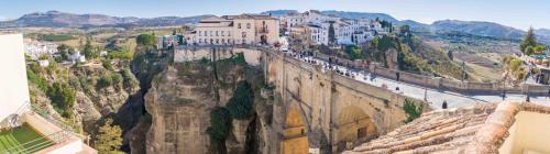 a city on top of a mountain with buildings at Hotel Don Miguel in Ronda