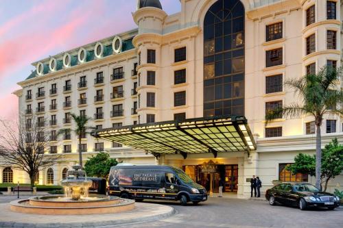 a building with a van parked in front of it at Peermont D'oreale Grande at Emperors Palace in Kempton Park