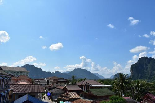 a view of a town with mountains in the background at Nice view guesthouse in Vang Vieng