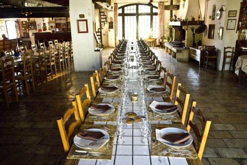 a long long table with chairs and plates on it at Lou Mas Dou Juge in Saintes-Maries-de-la-Mer