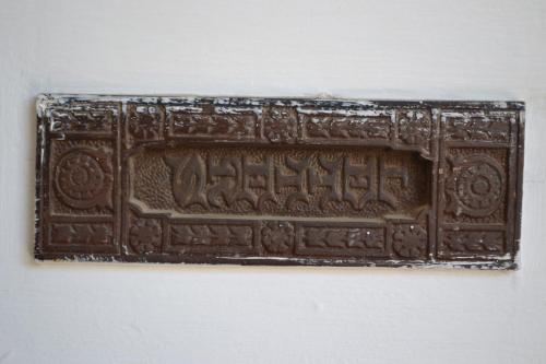 a close up of a chocolate plaque on a wall at Hobbit Boutique Hotel in Bloemfontein