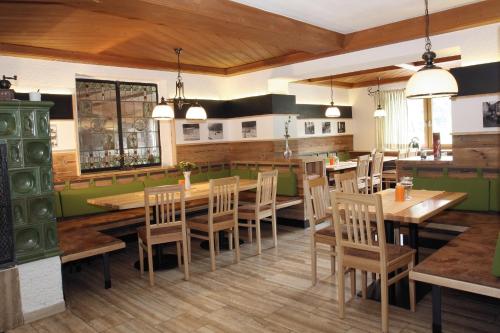 a dining room with wooden tables and chairs at Gasthof Hotel zur Post in Erlau