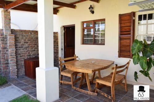 a table and chairs on the porch of a house at Paul Kruger 63 in Robertson