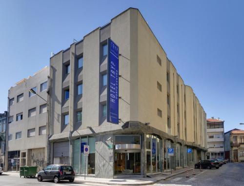 a building with a sign on the side of it at TRYP by Wyndham Porto Centro Hotel in Porto