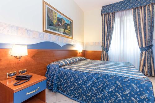Postel nebo postele na pokoji v ubytování Hotel Borgo Del Mare