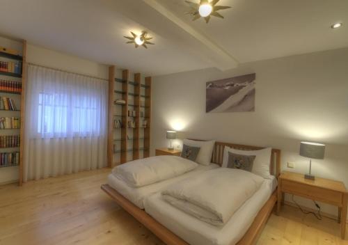 a bedroom with a large white bed in a room at Chalet Anna Maria by Kaprun Rentals in Kaprun