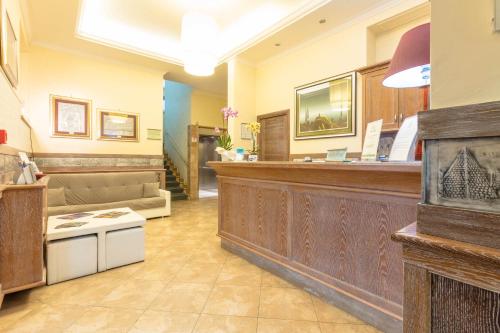 a lobby with a counter and a waiting room at Hotel Borgo Del Mare in Civitavecchia
