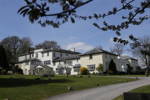 a large white house with a driveway in front of it at Lord Haldon Country Hotel, Sure Hotel Collection by Best Western in Exeter