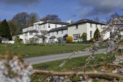 a large white house with a road in front of it at Lord Haldon Country Hotel, Sure Hotel Collection by Best Western in Exeter