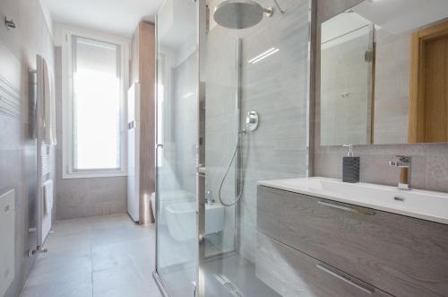 a bathroom with a glass shower and a sink at Corte Maggiore in Ravenna