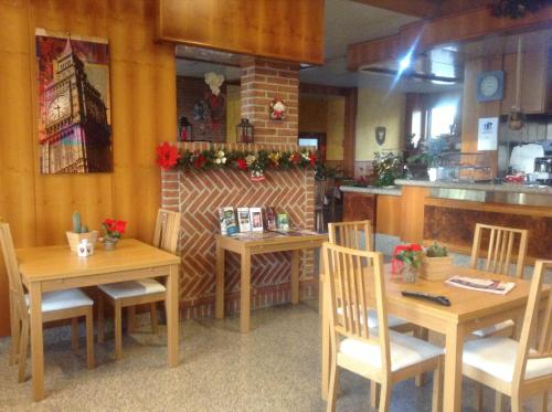 a restaurant with wooden tables and chairs and a counter at Hotel Route 9 in Cadeo