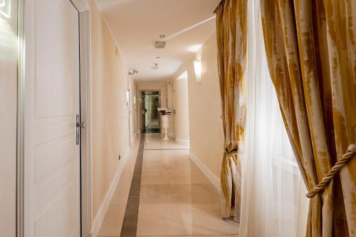 a hallway with a door and a long hallway at Demetra Hotel in Rome