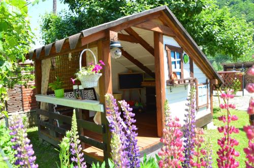 a wooden play house in a garden with flowers at Fachwerk in Yaremche