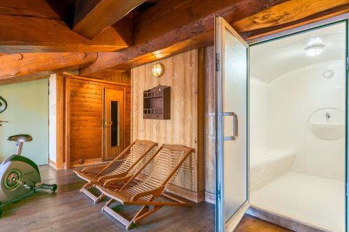 a room with two chairs and a sliding glass door at Hotel Kandahar in Val dʼIsère