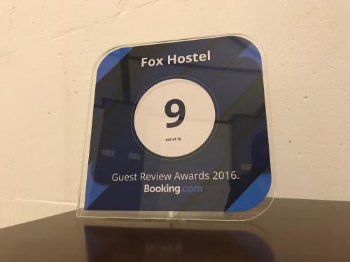 a clock with a fox hospital sign on it at FOX Hostel in Mykolaiv