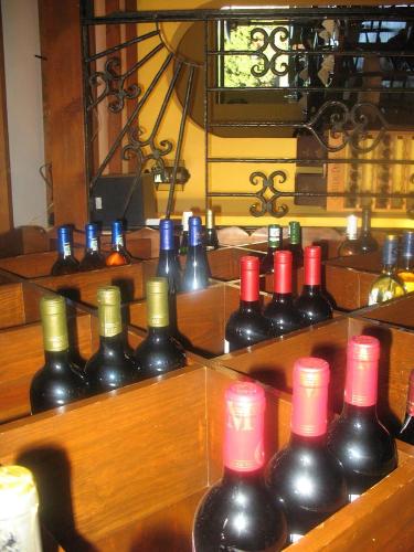 a bunch of wine bottles sitting on a shelf at Casa Cantarranas in Tehuacán