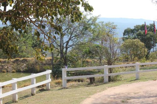 a white fence on the side of a road at Ashbourne Country Escape Hazyview in Hazyview