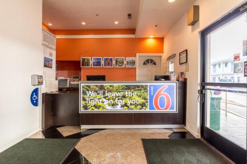 a lobby with a large television in a store at Motel 6 San Rafael in San Rafael