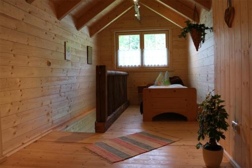 a room with a fireplace in a wooden cabin at Forstauer's Teichalm in Gams bei Hieflau