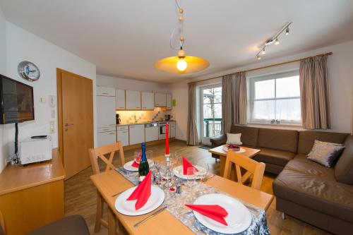 ein Wohnzimmer mit einem Tisch mit roten Servietten darauf in der Unterkunft Appartements Romantika & Appartement Barbara in Wagrain