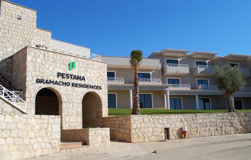 a building with a sign that reads pismo granada headquarters at Pestana Gramacho Residences in Ferragudo
