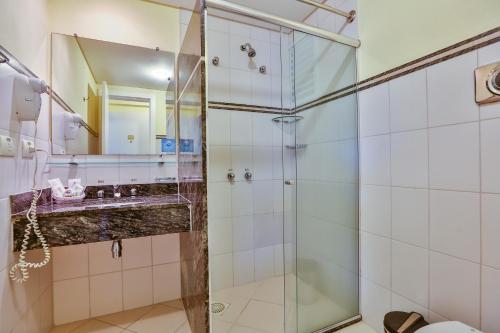 a bathroom with a shower and a sink at Dubai Macaé by Atlântica in Macaé