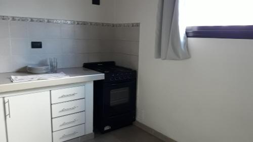 a kitchen with a stove and a white counter top at Apartamento La Plata in La Plata