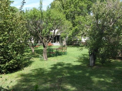 a picnic table in the middle of a yard with trees at Plaza Hotel in Capilla del Monte