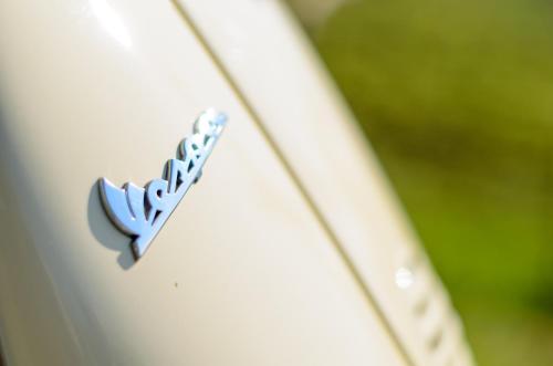 a logo on the side of a white car at Vineus Tramin in Termeno