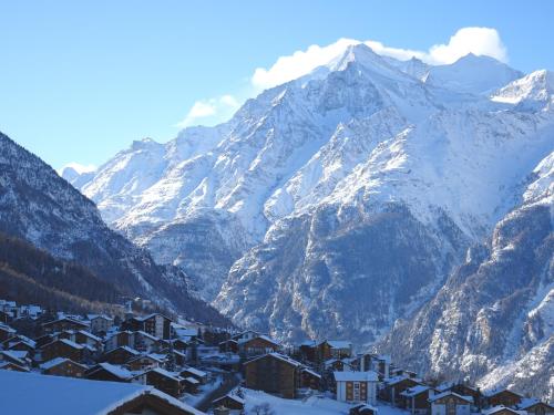 a town in front of a snowy mountain range at Sunnegga in Grächen
