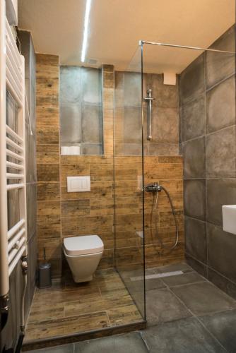 a bathroom with a toilet and a glass shower at Nordic Hostel N-Box in Skopje