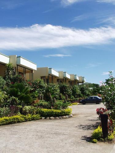 a car parked in front of a row of houses at Grand West Villas in Nadi