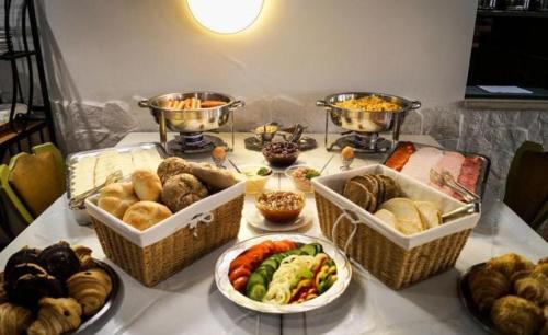 a table with baskets of different types of food at Korona Panzió Budapest in Budapest