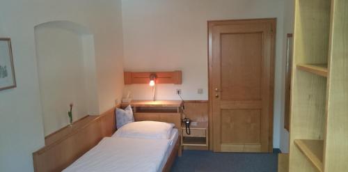 a hotel room with two beds and a door at Hotel zum goldenen Hirschen in Göstling an der Ybbs